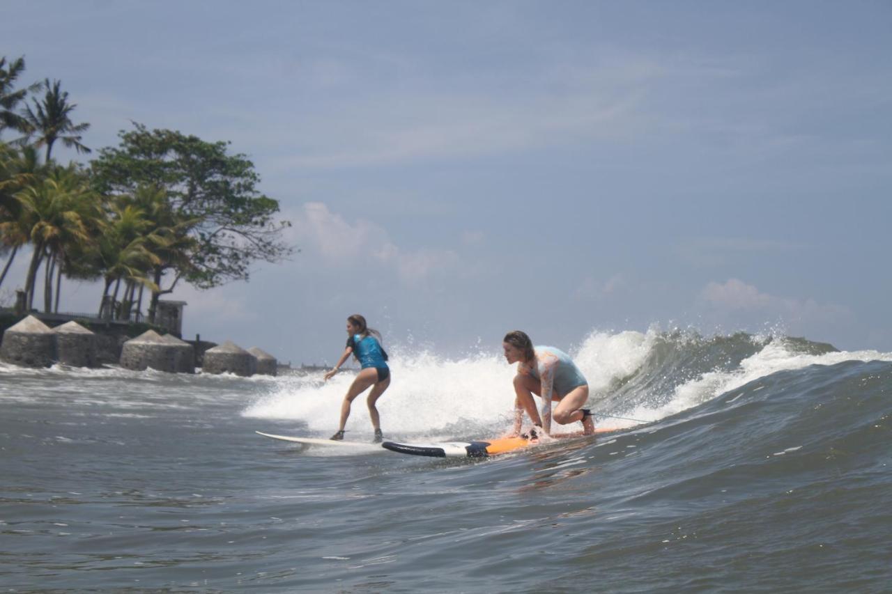 Surfers And Medewi *
